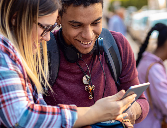 two high school students looking at their phones