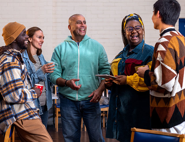 group of diverse adults at a community center talking