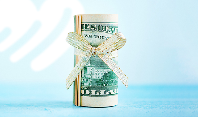 roll of money tied in a bow